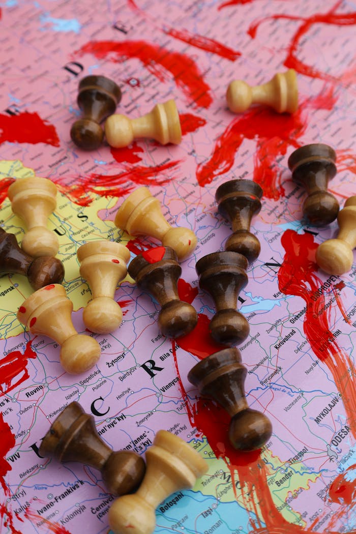 Chess pieces on a world map highlight the strategic aspect of global conflicts.